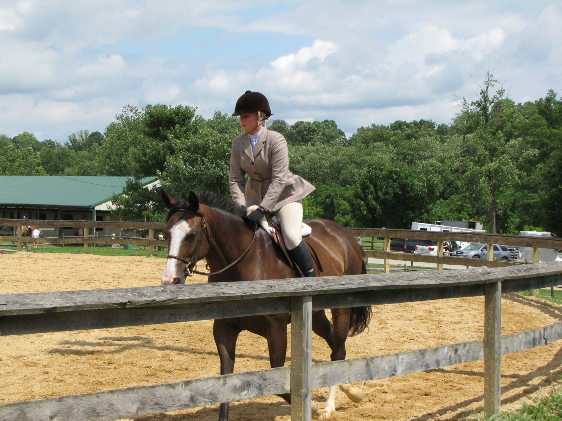 a woman on a horse wearing a black helmet
